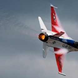 A United States Air Force F-16 Viper races across the sky afterburner ablaze