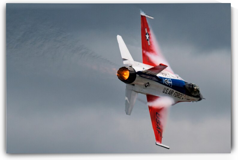A United States Air Force F-16 Viper races across the sky afterburner ablaze by Pisarek Photography